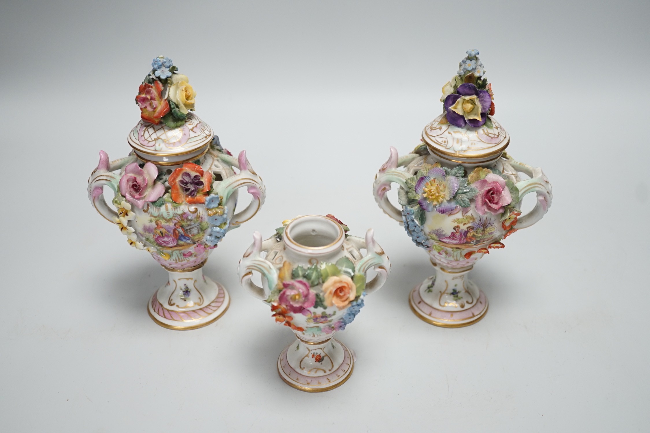 Three 19th century Dresden floral encrusted vases, two with covers, 16cm